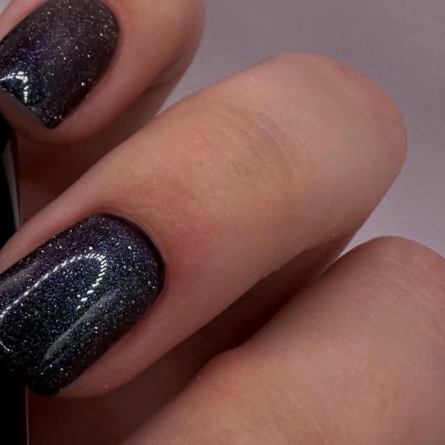 Black glitter manicure, close up