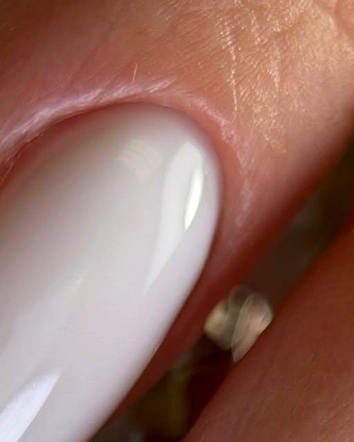 Milky white Russian manicure showing precise cuticle work, close up